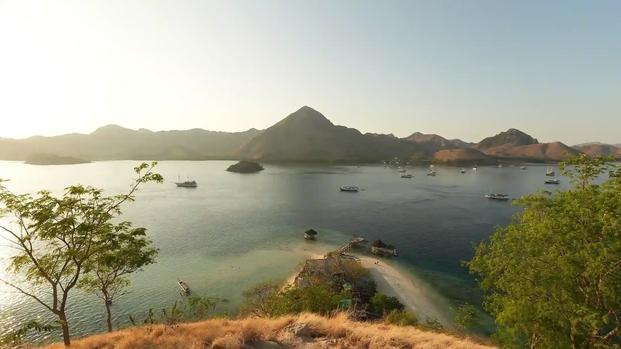 Kelor Island and its conical green hill rising from the shallows in Komodo National Park