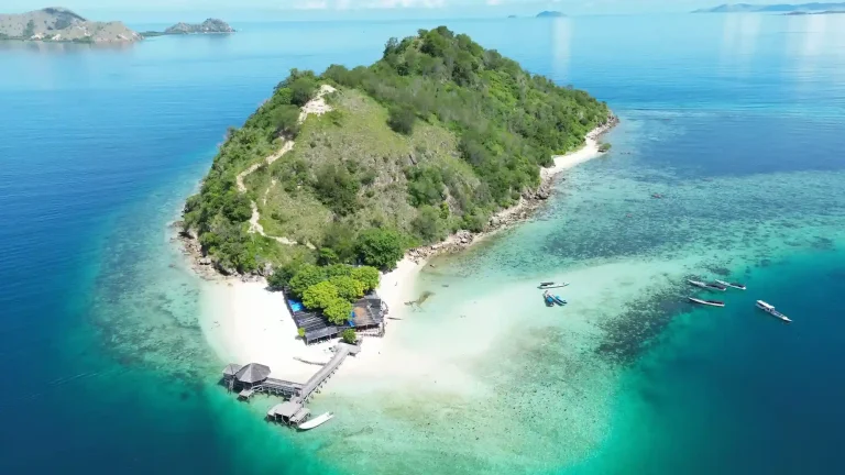 Kelor Island with its conical green hill and white sand beach in Komodo National Park
