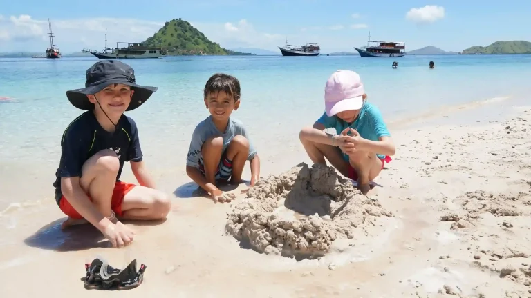 Children playing in the shallows off Kelor Island on a family Komodo trip