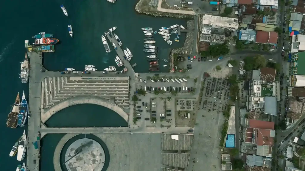 Labuan Bajo harbour with phinisi liveaboards moored along the waterfront