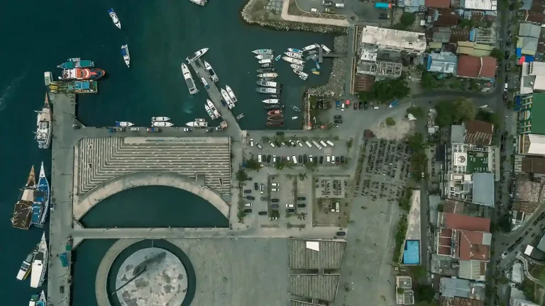 Labuan Bajo harbour with phinisi liveaboards moored along the waterfront