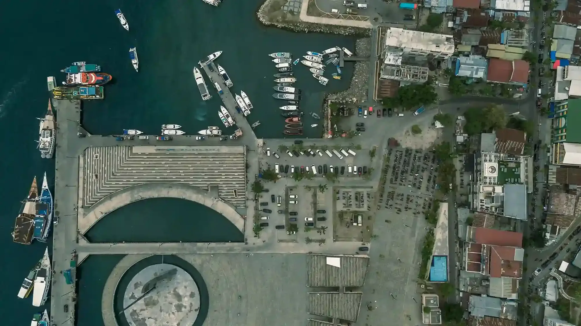 Labuan Bajo harbour with phinisi liveaboards moored along the waterfront