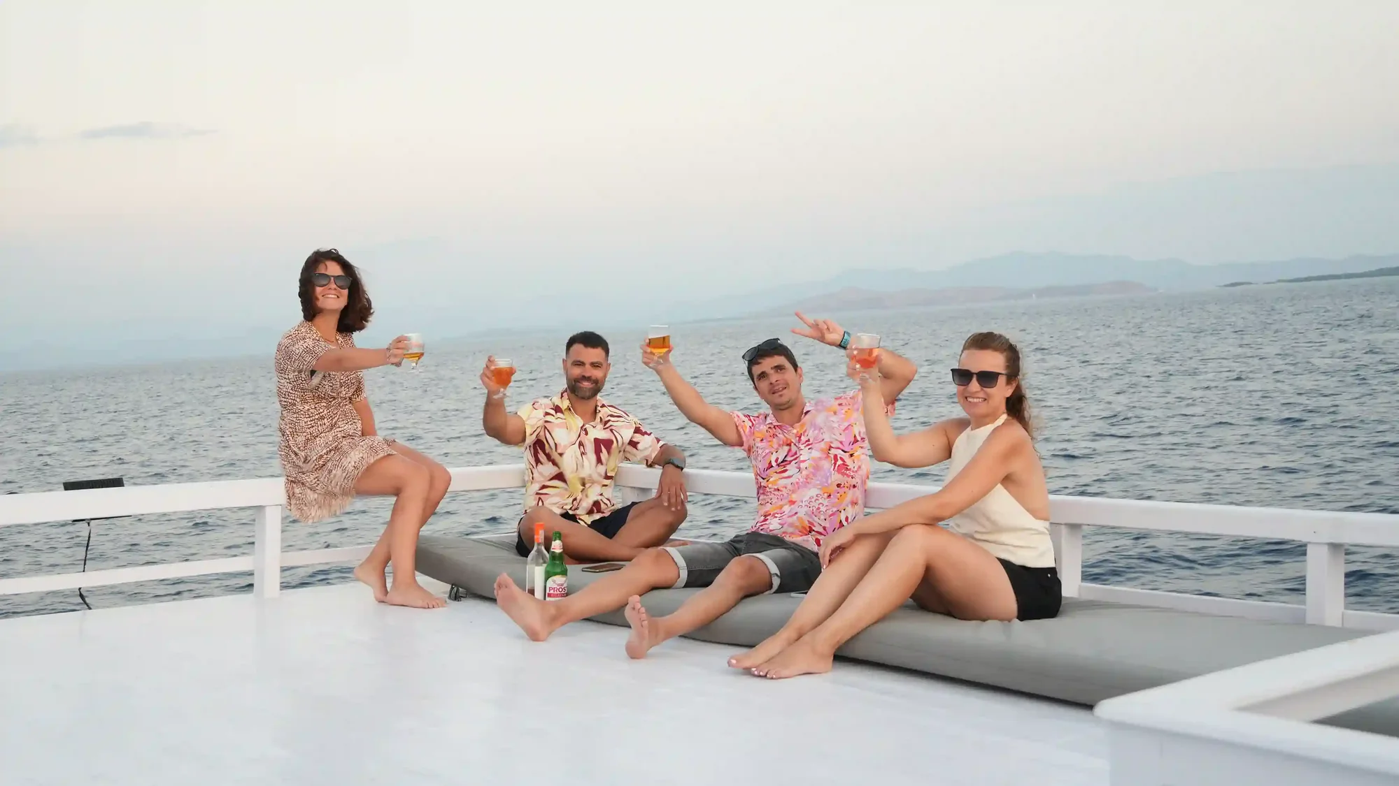 Guests relaxing on the foredeck of a phinisi while under way in Komodo